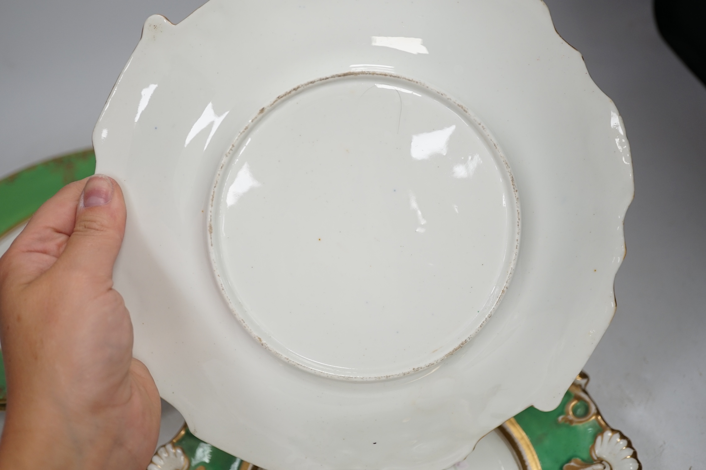 A group of English porcelain green ground dessert plates and dishes, largest 24cm diameter. Condition - fair